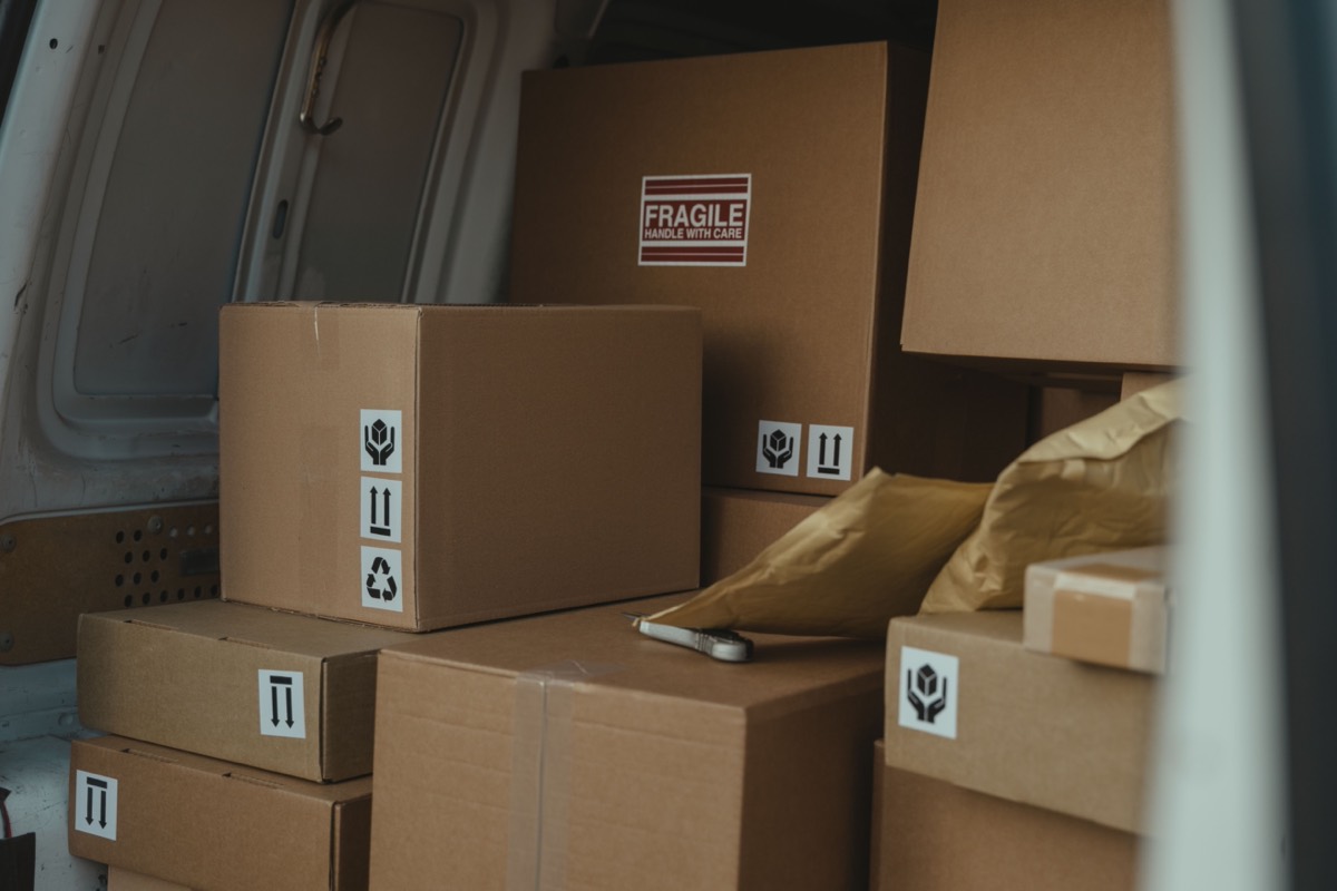 Parcels secured inside a delivery van for transport.